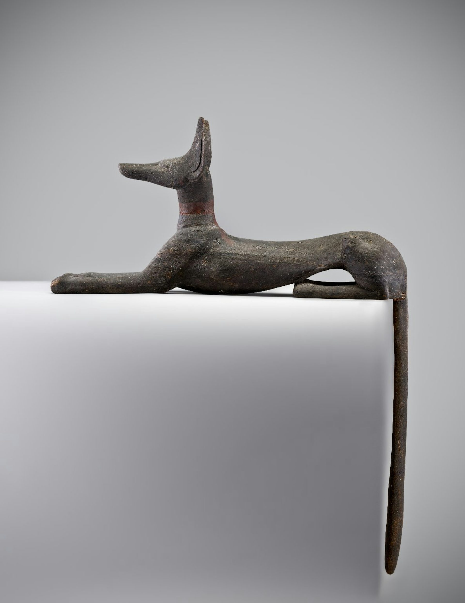 wooden statue of Anubis as jackal
