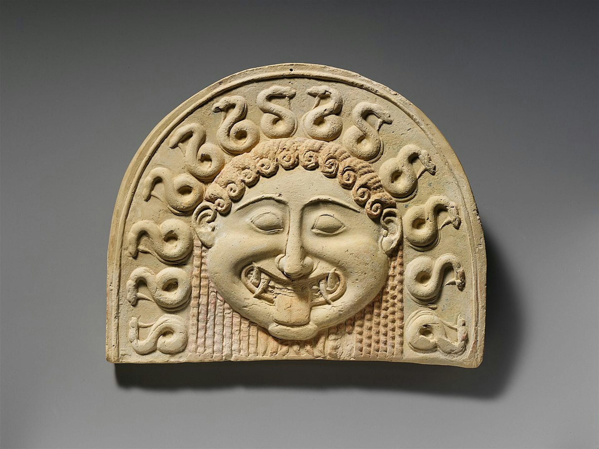 Terracotta painted gorgoneion antefix (roof tile) MET