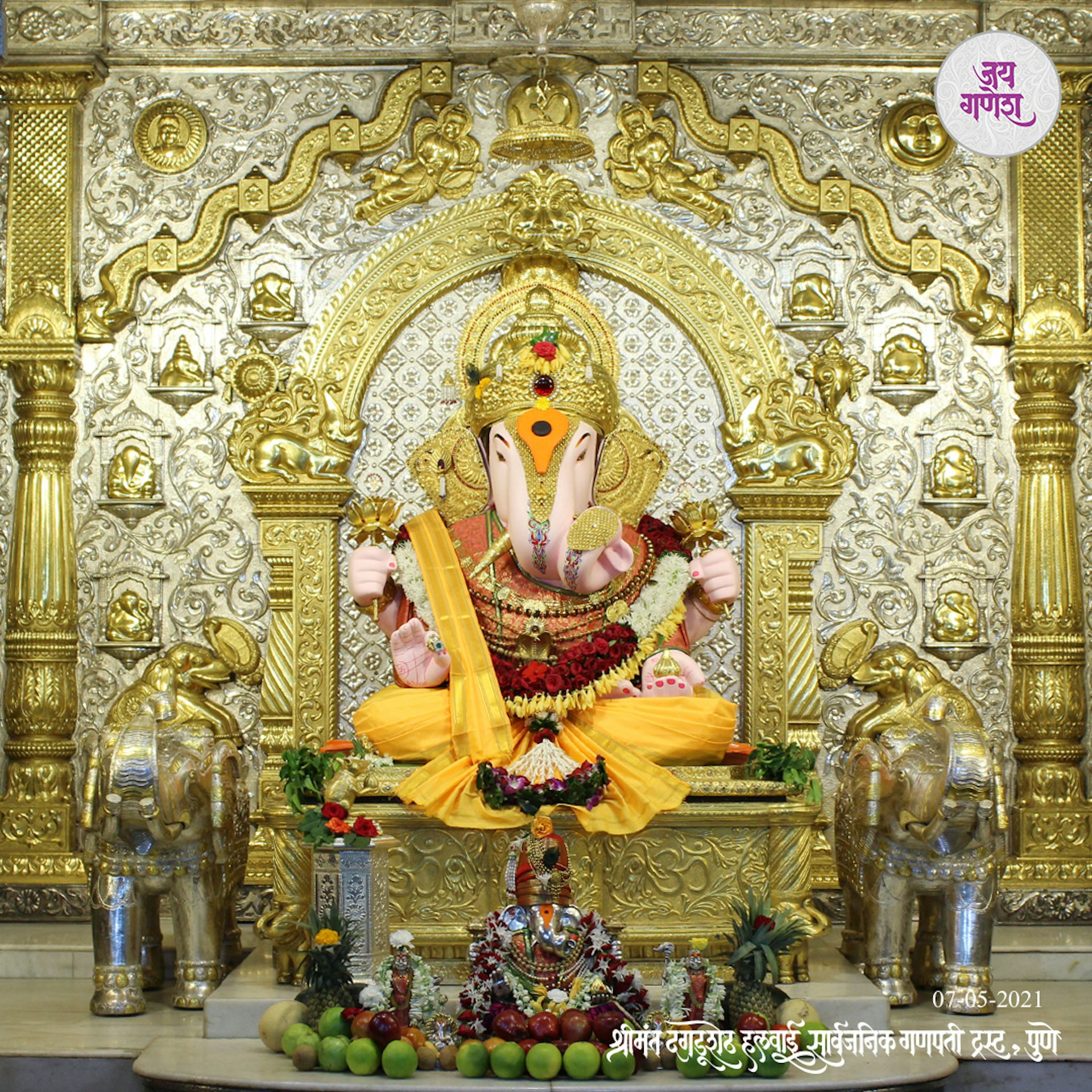 Richly ornamented statue of Ganesha flanked by elephants at the Shreemant Dagdusheth Halwai Ganapati temple.